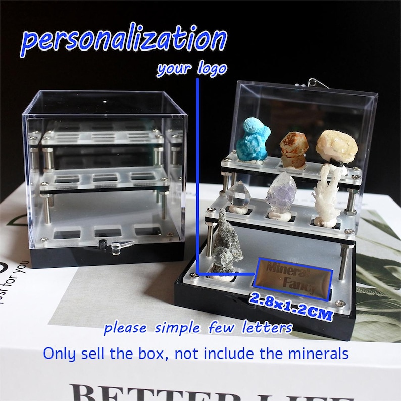 May include: A clear acrylic display box with two shelves for displaying small items, such as minerals. The box has a black base and a removable lid. The box is 7.1 cm by 3 cm. The text "Minera Fancy" is printed on a label on the front of the box. The text "personalization your logo" is printed above the box.