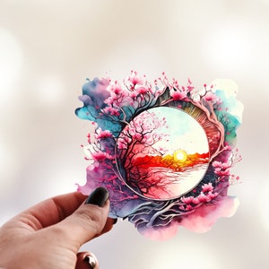 May include: Watercolor painting of a pink cherry blossom tree with a circular window revealing a sunset over a lake. The tree branches are intertwined with the window frame.