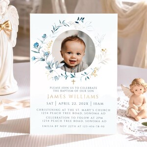 May include: A baptism invitation card featuring a baby's photo within a floral wreath. The card includes event details: James Williams, April 22, 202X, 10 AM, and the christening location. Decorative elements include angel figurines and a lit candle.