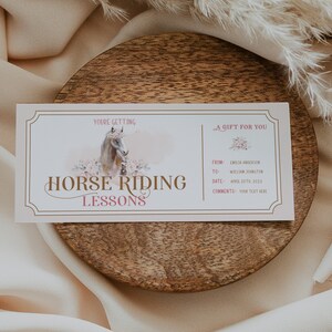 Peut inclure: Un bon cadeau pour des cours d'&eacute;quitation. Le design pr&eacute;sente une illustration &agrave; l'aquarelle d'un cheval et des motifs floraux. Le texte comprend "You're Getting", "Horse Riding Lessons", et "A Gift For You". Des champs pour le destinataire et la date sont &eacute;galement pr&eacute;sents.