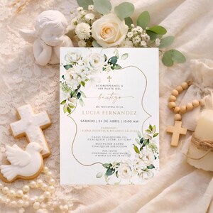 Bautizo invitation flat lay with white peony corners, gold scroll frame, cookies, and rosary beads on lace fabric
