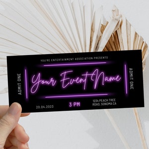 May include: Black ticket with white text that reads "You're Entertainment Association Presents" and "Your Event Name" in pink neon lettering. The ticket also includes the date "20.04.2023", time "3 PM", and location "1234 Peach Tree Road, Sonoma CA".