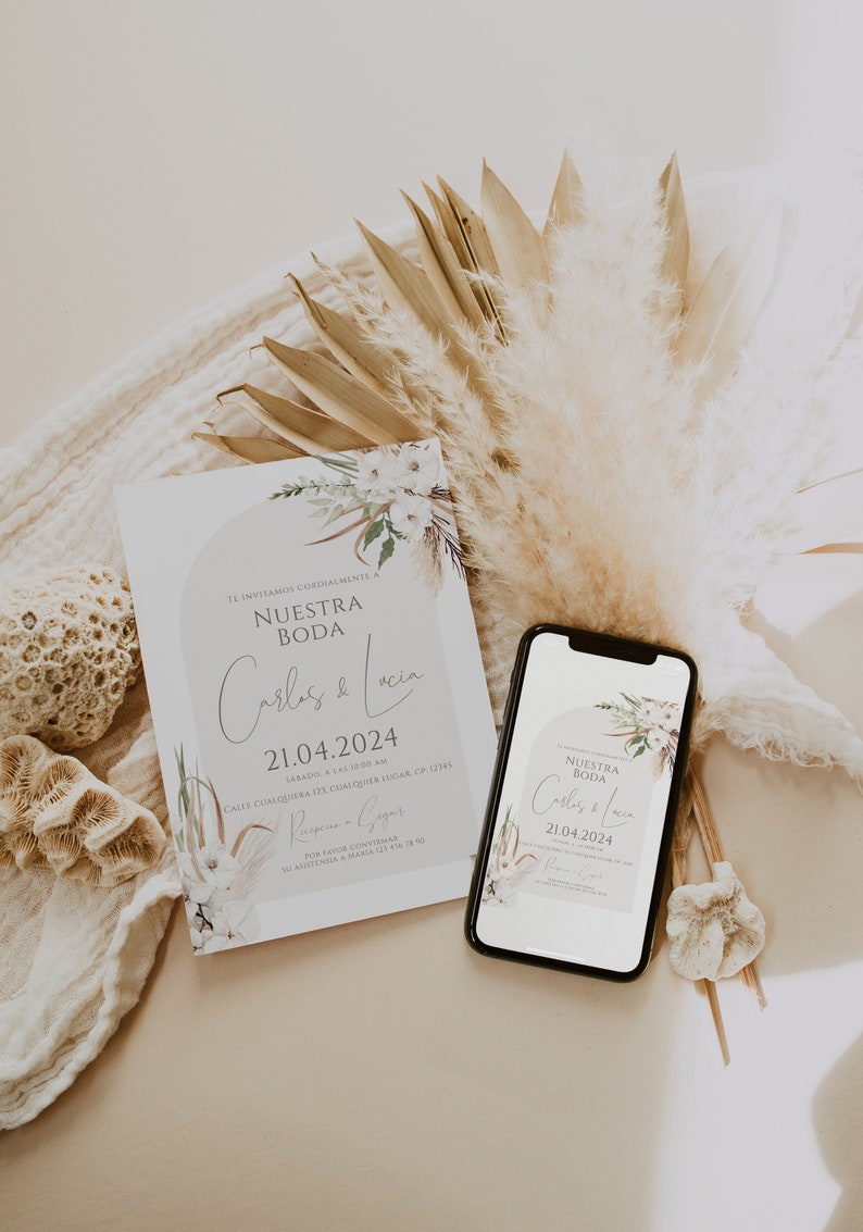 May include: A rectangular wedding invitation card and a smartphone displaying the same invitation design. The design features the text "NUESTRA BODA", "Carlos & Lucia", and "21.04.2024" with floral illustrations in muted earth tones and beige.