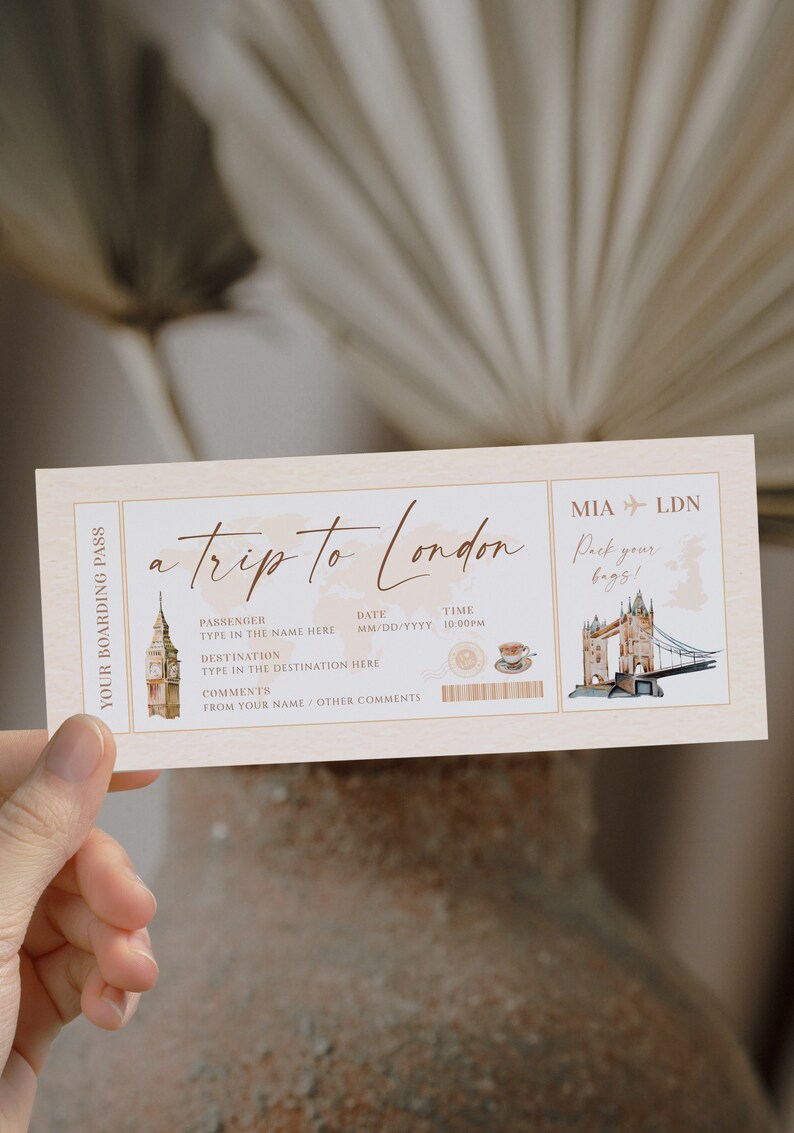 May include: A rectangular boarding pass invitation with a cream background featuring the text a trip to London, MIA to LDN, and Pack your bags. It includes watercolor illustrations of Big Ben, Tower Bridge, a teacup, and a world map graphic.