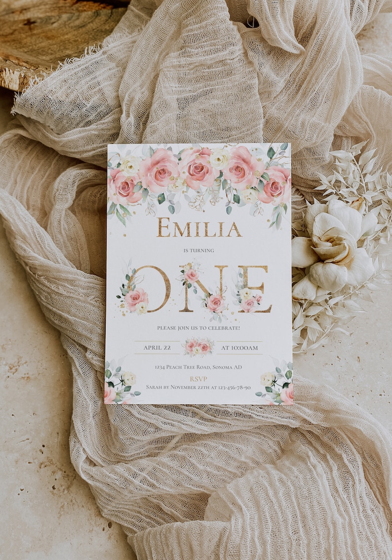 May include: A rectangular birthday invitation card featuring a watercolor floral border of pink roses and green leaves. The text reads EMILIA IS TURNING ONE, PLEASE JOIN US TO CELEBRATE, APRIL 22 AT 10:00AM, 1234 PEACH TREE ROAD, SONOMA AD, RSVP SARAH BY NOVEMBER 22TH AT 123-456-78-90.