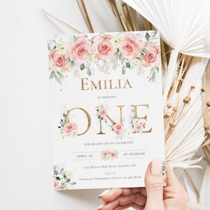 May include: A rectangular invitation card featuring a floral border of pink and white roses with green leaves. The text reads EMILIA IS TURNING ONE, PLEASE JOIN US TO CELEBRATE, APRIL 22 AT 10:00AM, 1234 PEACH TREE ROAD, SONOMA AD, RSVP SARAH BY NOVEMBER 22TH AT 123-456-78-90.
