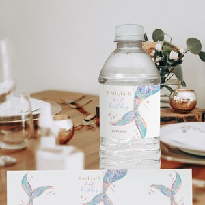 a bottle of water sitting on top of a wooden table