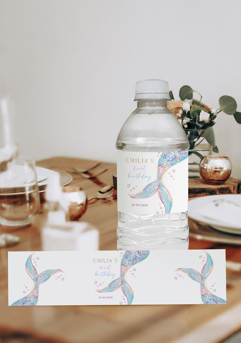 a bottle of water sitting on top of a wooden table