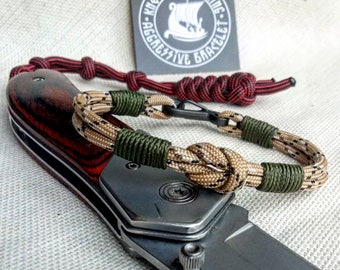 Thin military bracelet made of paracord and carabine for men. Camouflage desert camo. Army style.