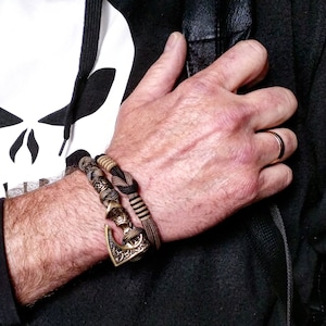 Viking bracelet made of paracord, Celtic knots and original beads made of brass with the image of ancient Scandinavian patterns. Mens style.
