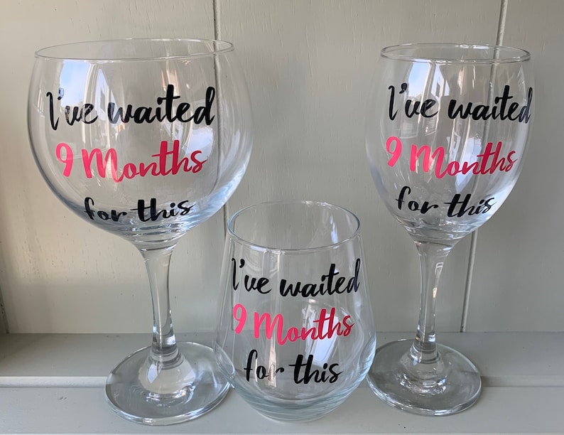 Three clear glass drinking glasses with black and pink lettering that reads "I've waited 9 Months for this".