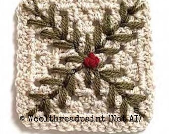 May include: A square crochet motif in cream yarn featuring an embroidered olive green leaf pattern radiating from the center, which is accented by a small red yarn knot. The text "© Woolthreadpaint (Not AI)" is printed at the bottom.