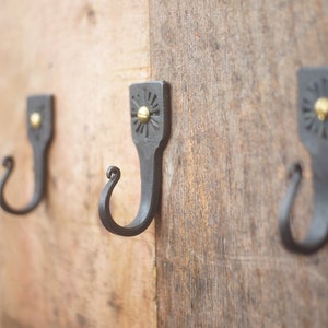 Hand forged decorative hooks. With brass screws.