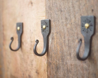 Hand forged decorative hooks. With brass screws.