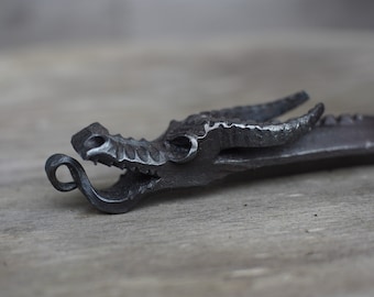 Forged dragon head bottle opener.