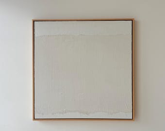 May include: A square canvas painting featuring a textured off-white and cream color palette with visible brushstrokes, enclosed in a light-toned wooden frame. The composition displays horizontal bands of varying neutral shades and paint thickness.