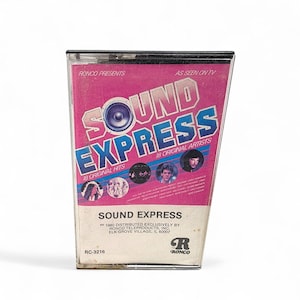 May include: A vintage cassette tape for "Sound Express" featuring 18 original hits and artists. The cassette case has a pink and blue design with the text "AS SEEN ON TV" and the Ronco logo. The tape is from 1980.