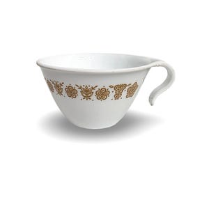 May include: White teacup with a curved handle and a decorative band of gold floral patterns around the exterior. The cup has a wide opening and a rounded base, suitable for serving hot beverages.
