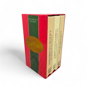 May include: A boxed set of Reader's Digest Christmas VHS tapes. The red box has a green ribbon design with gold lettering that reads "The Wonder of Christmas." The VHS tapes include "A Scenic Celebration," "Christmas Classics," and "A Fantasy on Ice."