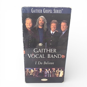 May include: A VHS tape from the Gaither Gospel Series featuring the Gaither Vocal Band. The cover has a dark blue background with the band members' portraits and the text "I Do Believe". The GGS logo is at the bottom.