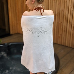 May include: White towel with the text "Mrs. Higgins" in cursive script and a small heart symbol.