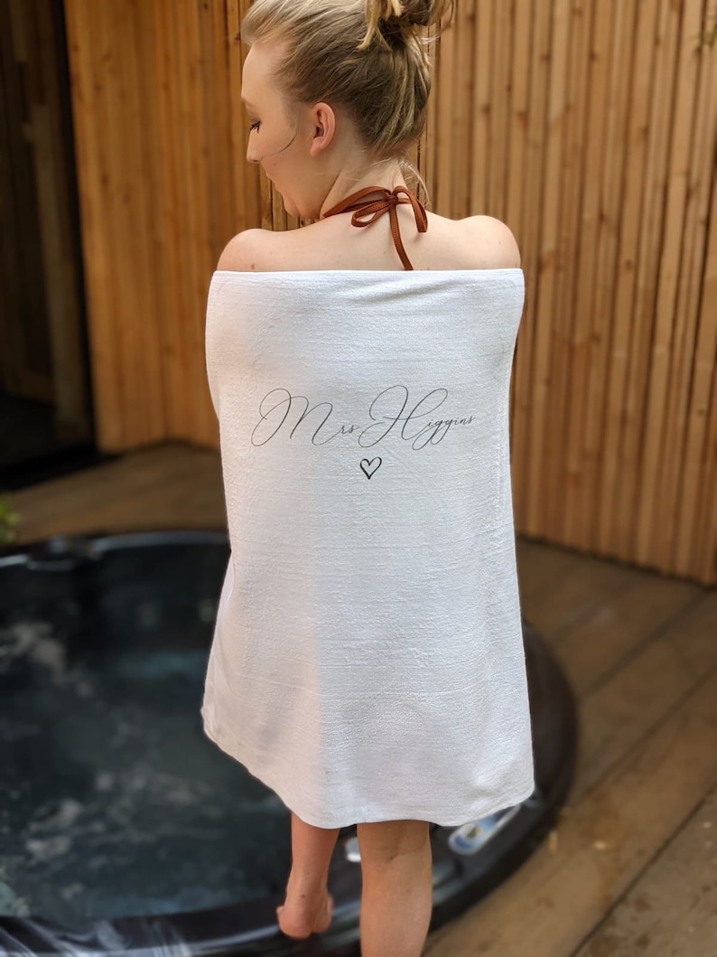May include: White towel with the text "Mrs. Higgins" in cursive script and a small heart symbol.