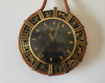 Wonderful Brass Zodiac Signs Design Wind Up Wall Clock wit Rope Hanger by Atlanta, 1960s, Germany