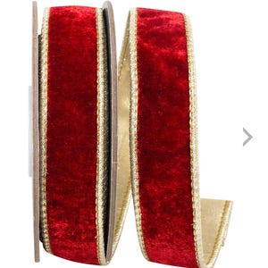 May include: A spool of red velvet ribbon with a gold trim. The ribbon is a deep red color and has a soft, velvety texture. The gold trim adds a touch of elegance. This ribbon is perfect for crafts and holiday decorations.
