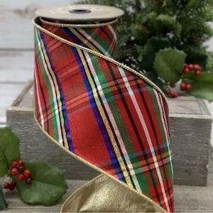May include: A roll of red plaid ribbon with gold trim. The ribbon features a classic tartan pattern with green, white, blue, and gold stripes. The ribbon is ideal for holiday decorations and gift wrapping.
