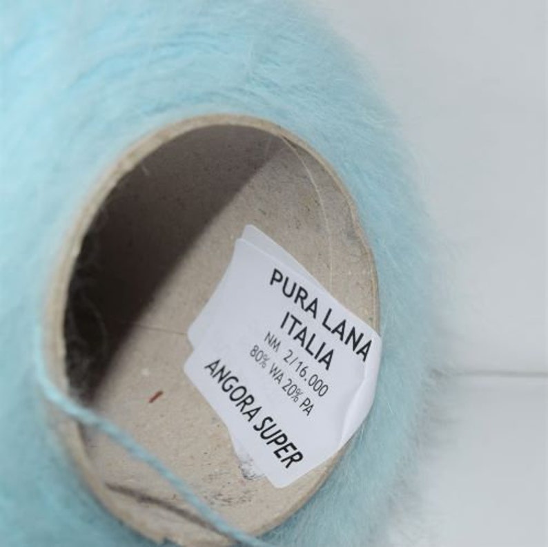 May include: A skein of light blue yarn labelled "PURA LANA ITALIA NM 2/16.000 80% WA 20% PA ANGORA SUPER".