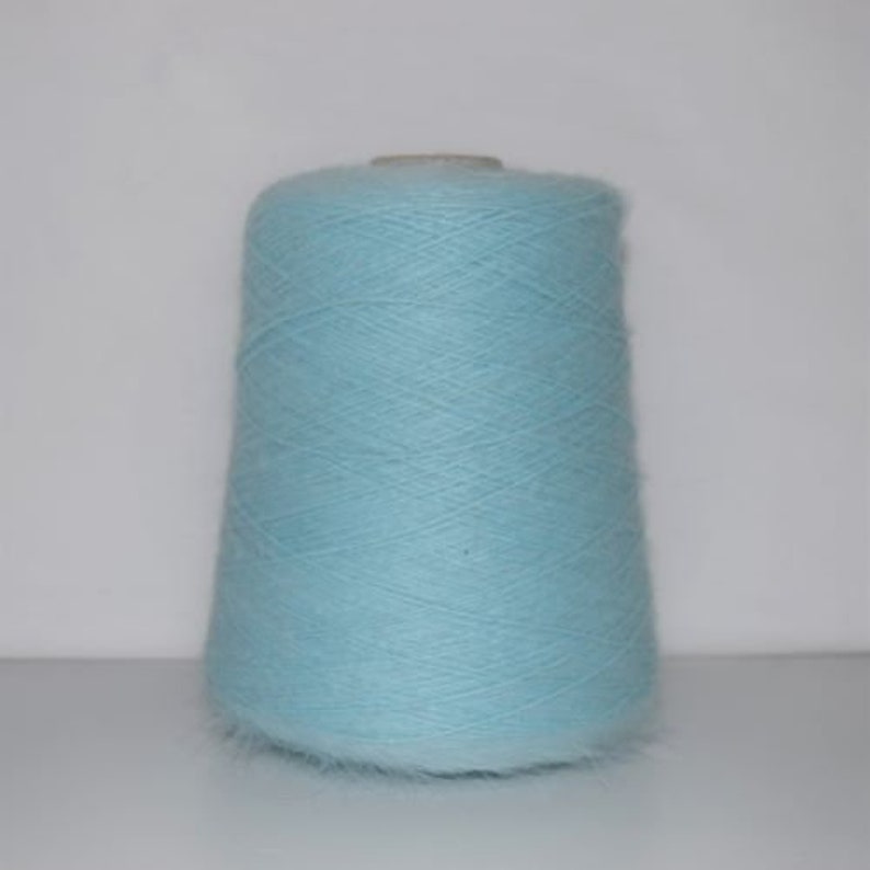 May include: A skein of light blue yarn, wound on a cardboard spool.