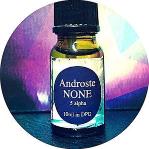 May include: A small glass bottle with a black cap and a blue label. The label reads "Androste NONE 5 alpha 10ml in DPG". The bottle contains a clear liquid with a yellow tint. The background is a mix of purple, blue, and white.