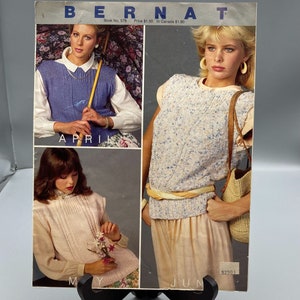May include: A vintage knitting pattern book from Bernat featuring three women wearing sleeveless sweaters. The book is titled "Bernat" and has the text "Book No. 578 Price $1.50 In Canada $1.80" printed on the cover. The models are wearing sweaters in blue, pink, and white.