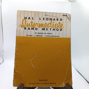 May include: A yellow book titled "Hal Leonard Intermediate Band Method" by Harold W. Rusch for drum. The book is for class, individual, and full band instruction. The price is $1.25.