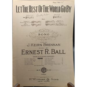 Puede incluir: Partitura antigua titulada "Let The Rest Of The World Go By", con letra de J. Keirn Brennan y música de Ernest R. Ball. La partitura vintage presenta notas musicales, texto y el logotipo del editor.