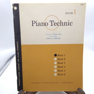 May include: Book cover for Piano Technic, a music book for piano students. The cover is yellow with black text and a black circle. The text on the cover reads "Piano Technic" and "Book 1". The cover also includes the publisher's name, "Summy Publishing Company".