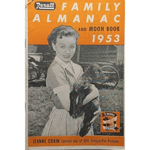 May include: A vintage Rexall Family Almanac and Moon Book from 1953. The cover features a black and white photo of actress Jeanne Crain holding a dark-colored lamb. The almanac has an orange header with white text.