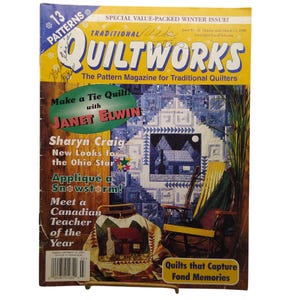 May include: A copy of Quiltworks magazine, issue 66, featuring a blue and white quilt pattern on the cover. The text includes '13 Patterns', 'Special Value-Packed Winter Issue', and 'Make a Tie Quilt with Janet Elwin'. A yellow rocking chair is visible.