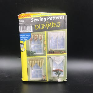 May include: A Simplicity sewing pattern for window treatments, featuring various curtain designs. The package is yellow and has the text "Sewing Patterns for Dummies" and "itch up a storm the Fun and Easy Way".