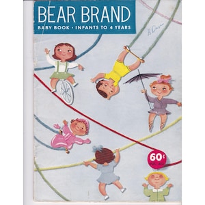 May include: Vintage "Bear Brand Baby Book" cover. The cover features illustrations of children performing circus acts. The title is in a blue banner at the top. The cover is light blue with red, yellow, and blue lines.
