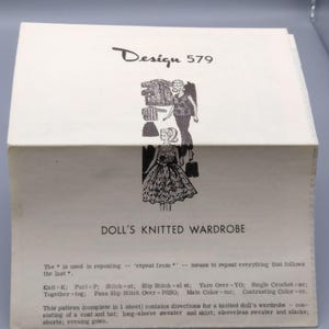 May include: A vintage pattern for a doll's knitted wardrobe. The cover is white with the text "Design 579" and illustrations of doll clothing. Includes instructions for a coat, hat, sweater, skirt, slacks, shorts, and an evening gown.