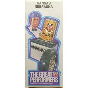 May include: Vintage advertisement featuring a man in a cap, a can of Phillips 66 Trop-Artic motor oil, a car battery, and a tire. The text reads "The Great Performers" and "Kansas Nebraska."