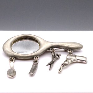 Vintage JJ Hair Stylist Charm Brooch, Silver Tone Vanity Mirror with Hairbrush, Comb, Scissors and Hair Dryer Dangles