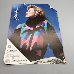 May include: A knitting pattern featuring a woman wearing a black, pink, blue, and green striped cardigan. The pattern is for a "Scenic Cardigan" made with "Maratona" 100% extra fine merino wool. The pattern is from "Lane Borgosesia" by "Zigna Baruffa" and is volume 58.