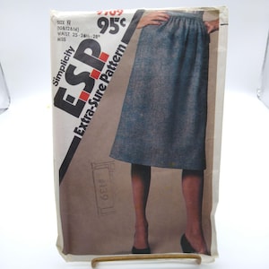 May include: Vintage Simplicity ESP Extra-Sure Pattern for a skirt, size N (waist 25-28 inches). The pattern packet features a drawing of the skirt in a blue fabric. The price is 95 cents. The pattern number is 7709.