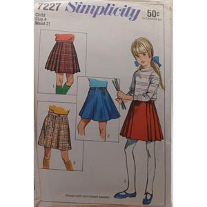 May include: Vintage Simplicity sewing pattern for a child's skirt, size 4, waist 21 inches. The pattern features illustrations of different skirt styles, including a pleated red skirt, a blue skirt, and a plaid skirt. The pattern cover has the Simplicity logo.
