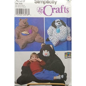 May include: Simplicity Crafts sewing pattern featuring three stuffed animal designs: a bear, a dalmatian, and a bear-shaped chair. The pattern includes instructions for creating these plush toys. The pattern is one size.