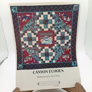 Puede incluir: Un tapiz de pared colorido titulado "Canyon Echoes" de Janet Page. El diseño presenta a una mujer nativa americana con un vestido turquesa sentada en el centro de un patrón geométrico. El fondo es de color rojo y azul con una variedad de formas y diseños geométricos.