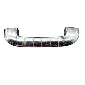 May include: A vintage, chrome-plated door handle with a curved design. The handle has a series of rectangular indentations along its length and shows signs of wear and age. The handle is set against a plain white background.