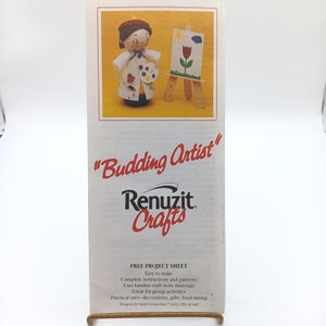 May include: A craft project sheet for making a "Budding Artist" craft. The sheet features a cartoon illustration of a person painting on a canvas with a paintbrush and a palette of paints. The project sheet is from Renuzit Crafts and includes instructions and patterns for making the craft.